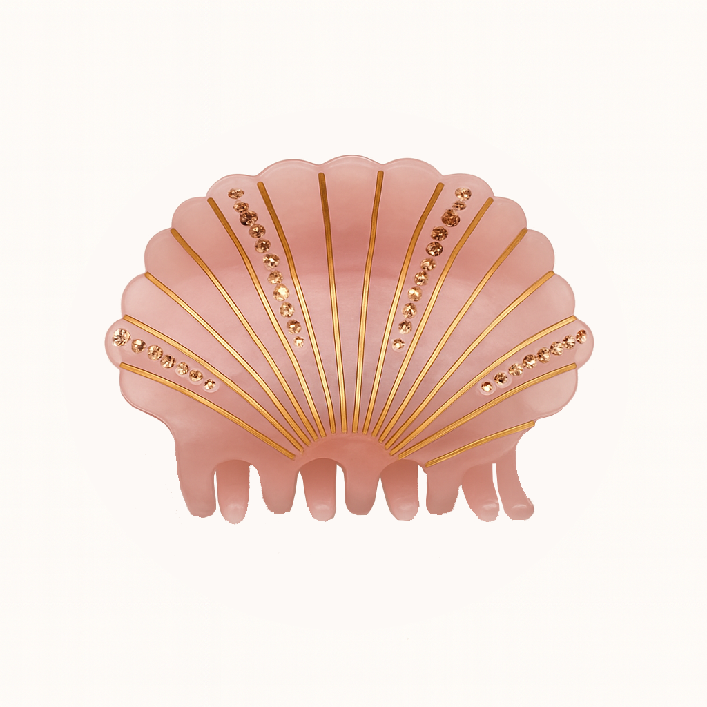 Pink shell-shaped hair clip with gold accents on a white background